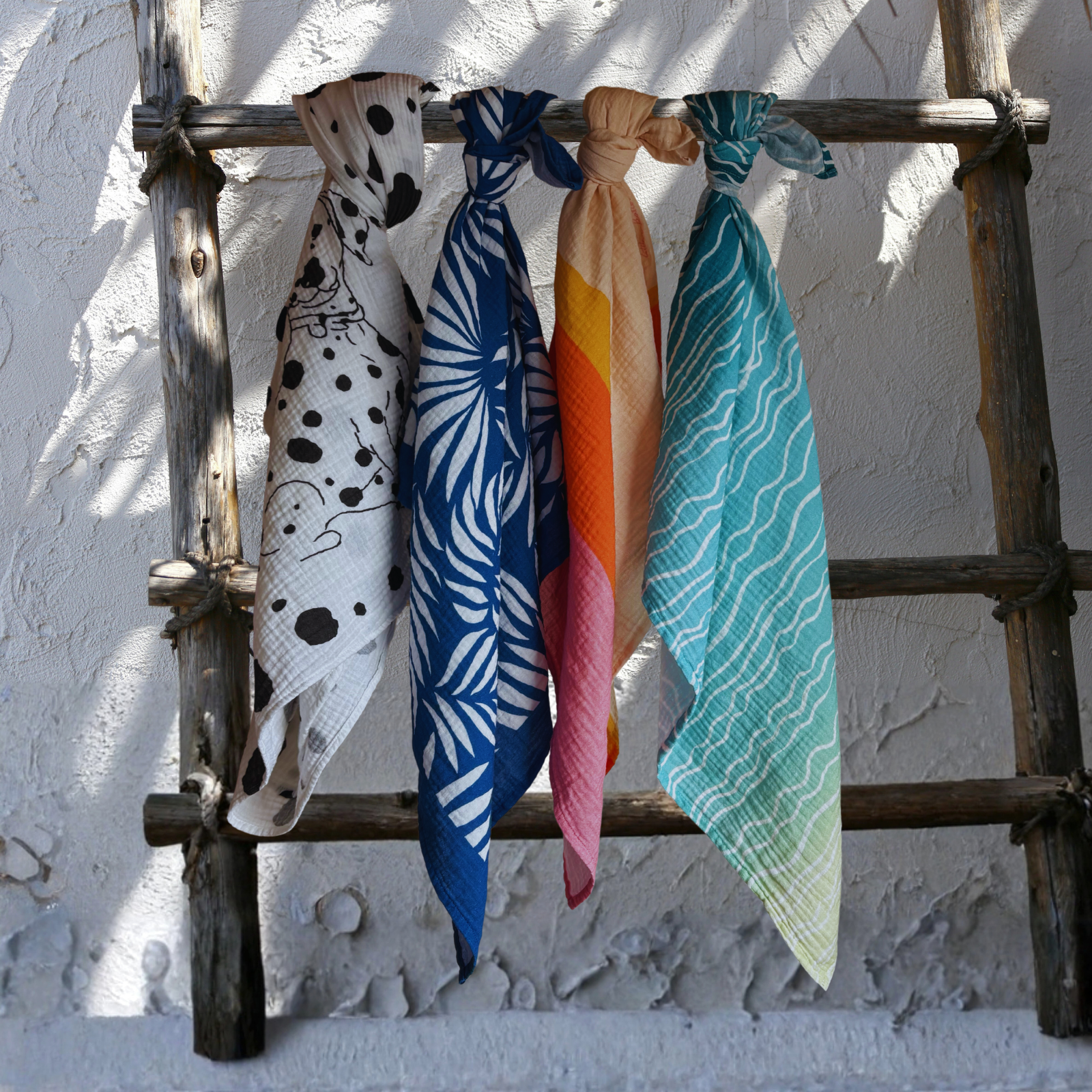 Large organic muslin bandanas in all our four debut design patterns, showcasing Little Battersea's sustainable luxury collection handcrafted in Portugal