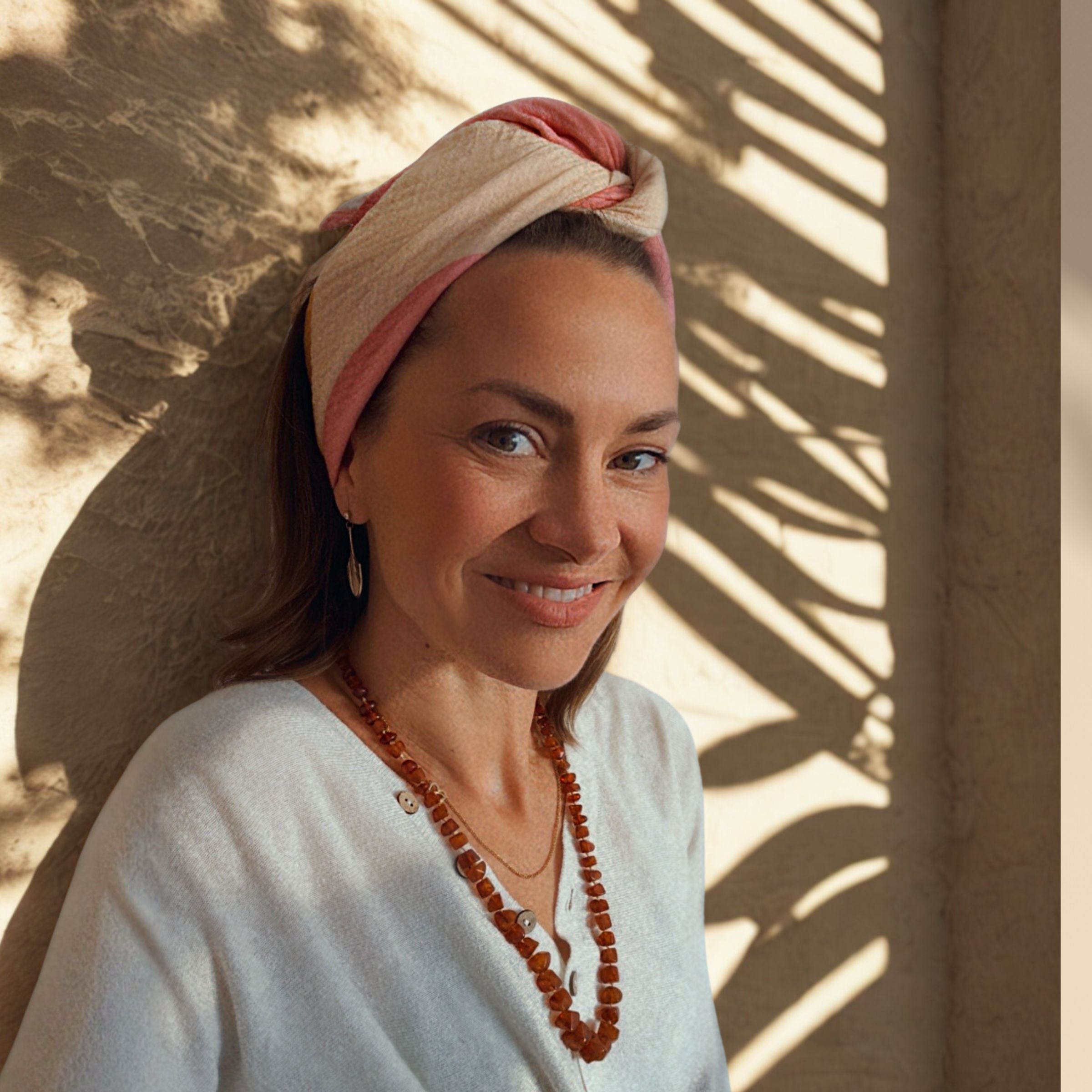 The Indra Small Square worn as a headband, showing styling and use beyond the newborn phase.